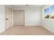 Clean bedroom featuring neutral carpet, sliding door closet, and natural light at 5433 E Nisbet Rd, Scottsdale, AZ 85254