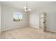 Neutral carpeted bedroom, decorative chandelier, closet, and large window at 5433 E Nisbet Rd, Scottsdale, AZ 85254