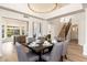 Dining area featuring wood floors, an elegant chandelier, and a staircase in the background at 5433 E Nisbet Rd, Scottsdale, AZ 85254