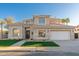 Beautiful two-story home with a well-manicured lawn, three car garage, and elegant design at 5433 E Nisbet Rd, Scottsdale, AZ 85254