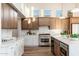 Kitchen featuring two-tone cabinets, stainless steel appliances, and eat-in island at 5433 E Nisbet Rd, Scottsdale, AZ 85254