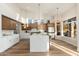 Modern kitchen with stainless steel appliances, a large island, and wood floors at 5433 E Nisbet Rd, Scottsdale, AZ 85254