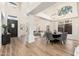 Elegant living room with wood floors, a large window, columns, and modern chandeliers at 5433 E Nisbet Rd, Scottsdale, AZ 85254