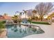 Beautiful backyard pool with a waterfall feature and lush landscaping at 5433 E Nisbet Rd, Scottsdale, AZ 85254