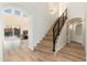 Modern staircase with wood steps and black railing at 5433 E Nisbet Rd, Scottsdale, AZ 85254