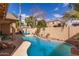 Lush backyard with sparkling pool, lounge chairs, and desert landscaping at 545 N Bluejay Dr, Gilbert, AZ 85234