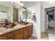 Bathroom featuring dual vessel sinks, granite countertops, wood cabinets, and a walk-in closet at 545 N Bluejay Dr, Gilbert, AZ 85234