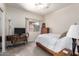 Simple bedroom with neutral carpet, a wooden bed frame, a TV, and a window with sheer curtains at 545 N Bluejay Dr, Gilbert, AZ 85234