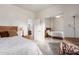 Spacious bedroom with mirrored closet doors, a wooden bed frame, and a view of the en-suite bathroom at 545 N Bluejay Dr, Gilbert, AZ 85234