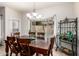 Dining room with wood table and view of pool from the large window at 545 N Bluejay Dr, Gilbert, AZ 85234