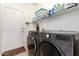 Well-equipped laundry room boasts modern washer and dryer, plus storage shelves at 545 N Bluejay Dr, Gilbert, AZ 85234