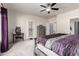 Main bedroom showcasing a comfortable bed, soft carpet, and convenient access to the backyard through a patio door at 545 N Bluejay Dr, Gilbert, AZ 85234