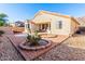 Inviting backyard with a brick-paved patio, desert landscaping, and a seating area perfect for outdoor living at 6009 W Questa Dr, Glendale, AZ 85310