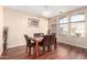 Elegant dining area with a chandelier, natural light, and wood-look flooring at 6009 W Questa Dr, Glendale, AZ 85310