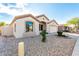 Inviting home with a well-kept yard and neutral-colored stucco exterior at 6009 W Questa Dr, Glendale, AZ 85310