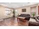 Cozy living room with a large window, wood-look flooring and neutral-colored walls at 6009 W Questa Dr, Glendale, AZ 85310