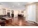 Open-concept living and dining area with wood flooring and neutral paint at 6009 W Questa Dr, Glendale, AZ 85310