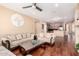 Cozy living room with wood floors open to the kitchen, perfect for entertaining at 6009 W Questa Dr, Glendale, AZ 85310