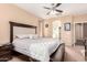 Bright main bedroom with a large bed, dark wood furniture, and an ensuite bath at 6009 W Questa Dr, Glendale, AZ 85310