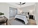 Well-lit bedroom with a ceiling fan, a queen bed, and a sliding glass door to the patio at 601 W Yukon Dr # 1, Phoenix, AZ 85027