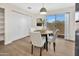 Bright dining area features a modern light fixture, sliding glass doors, and wood-style flooring at 601 W Yukon Dr # 1, Phoenix, AZ 85027