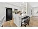 Modern kitchen with stainless steel appliances, white cabinets, a breakfast bar, and wood-look floors for a clean aesthetic at 601 W Yukon Dr # 1, Phoenix, AZ 85027