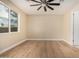 Spacious bedroom with wood flooring, a large window, and a modern ceiling fan to maximize comfort at 6223 S Eagle Pass Rd, Gold Canyon, AZ 85118