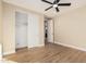 Comfortable bedroom featuring wood floors, an ensuite bathroom, and a walk-in closet at 6223 S Eagle Pass Rd, Gold Canyon, AZ 85118