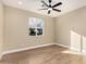 Well-lit bedroom with wood floors and a window offering pleasant neighborhood views at 6223 S Eagle Pass Rd, Gold Canyon, AZ 85118