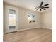 Bright bedroom with wood flooring, modern ceiling fan, and access to the backyard patio at 6223 S Eagle Pass Rd, Gold Canyon, AZ 85118