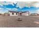 Charming single-story home featuring white siding, a gray roof, and a paved driveway at 6223 S Eagle Pass Rd, Gold Canyon, AZ 85118