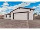 Charming single-story home featuring white siding, a gray roof, and a paved driveway at 6223 S Eagle Pass Rd, Gold Canyon, AZ 85118