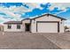 Charming single-story home featuring white siding, a gray roof, and a paved driveway at 6223 S Eagle Pass Rd, Gold Canyon, AZ 85118