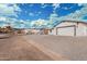 Charming single-story home featuring white siding, a gray roof, and a paved driveway at 6223 S Eagle Pass Rd, Gold Canyon, AZ 85118