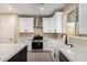 Bright kitchen with white cabinets, stainless steel appliances, and a stylish sink overlooking the backyard at 6223 S Eagle Pass Rd, Gold Canyon, AZ 85118