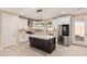 Modern kitchen featuring white cabinets, stainless steel appliances, and a center island for food preparation at 6223 S Eagle Pass Rd, Gold Canyon, AZ 85118