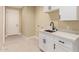 Laundry room features sleek white cabinets, modern countertops, and a convenient utility sink at 6223 S Eagle Pass Rd, Gold Canyon, AZ 85118