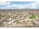 Expansive aerial view of a desert community with mountain views, golf course, and blue skies at 6460 E Trailridge Cir # 2, Mesa, AZ 85215