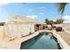 The backyard has a travertine pool deck, hot tub, mature landscaping, and desert rock at 6460 E Trailridge Cir # 2, Mesa, AZ 85215