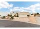 Single story desert home featuring an attached two-car garage, concrete driveway, and desert landscaping at 6460 E Trailridge Cir # 2, Mesa, AZ 85215