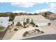 Expansive desert home boasts mature landscaping, decorative rock features and a circular driveway at 6460 E Trailridge Cir # 2, Mesa, AZ 85215