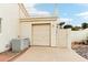 Exterior view of a garage with a beige door, air conditioning unit, and gate at 6460 E Trailridge Cir # 2, Mesa, AZ 85215