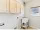 Bright laundry room features neutral walls, a white sink, and ample storage cabinets at 6460 E Trailridge Cir # 2, Mesa, AZ 85215