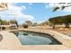 A lovely backyard pool with a travertine tile surround, a metal fence, and low bushes at 6460 E Trailridge Cir # 2, Mesa, AZ 85215