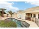 An in-ground backyard pool with a desert rock surround near a stucco house at 6460 E Trailridge Cir # 2, Mesa, AZ 85215