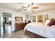 Bright bedroom features a ceiling fan, wood-look floors, and decoratively framed art pieces at 6533 N 7Th Ave # 22, Phoenix, AZ 85013