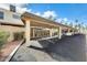 Designated carport area with covered parking spaces and well-maintained asphalt at 6533 N 7Th Ave # 22, Phoenix, AZ 85013