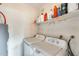 Functional laundry room with a washer, dryer, and shelving for storage at 6533 N 7Th Ave # 22, Phoenix, AZ 85013