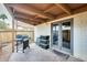 Relaxing outdoor patio area with weathered pavers, grill, and partially covered ceiling at 6533 N 7Th Ave # 22, Phoenix, AZ 85013