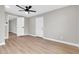 Bedroom featuring light walls, wood-look floors and ceiling fan at 7113 E Bell Cir, Mesa, AZ 85208